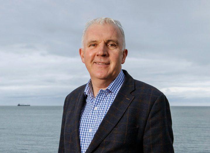 Headshot of founder and CEO of Snapfix, Paul McCarthy, with the sea in the background.