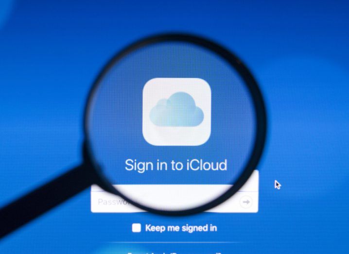 Magnifying glass zooming into a screen with the iCloud login page open.