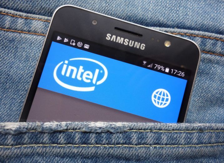 Samsung smartphone in the pocket of a pair of jeans with the screen displaying the Intel logo.