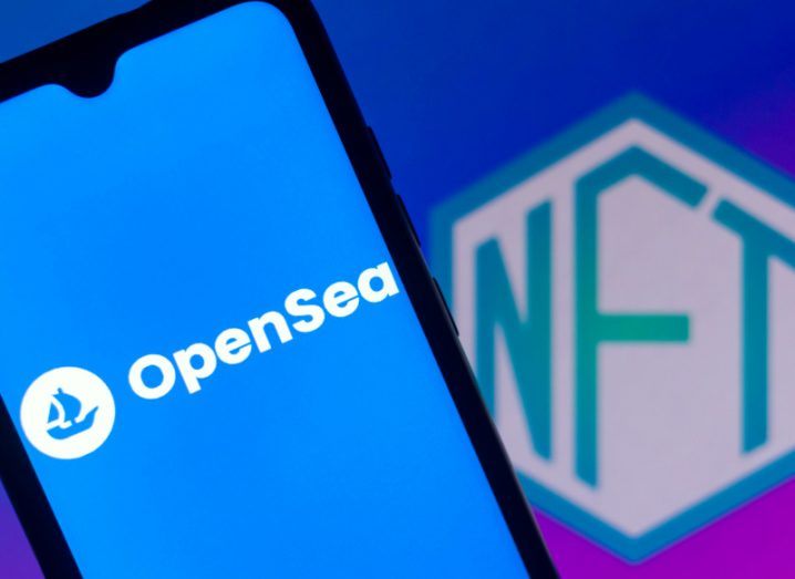 OpenSea logo and branding on a smartphone screen, with NFT written in the background.