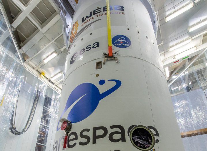 Webb is encapsulated in its Ariane 5 launcher fairing. The video camera developed by Réaltra Space Systems Engineering is visible in the middle of the image, between the two technicians.