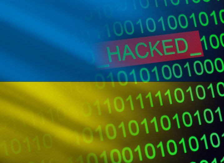 Ukrainian flag with binary numbers on it and text that reads ‘hacked’.