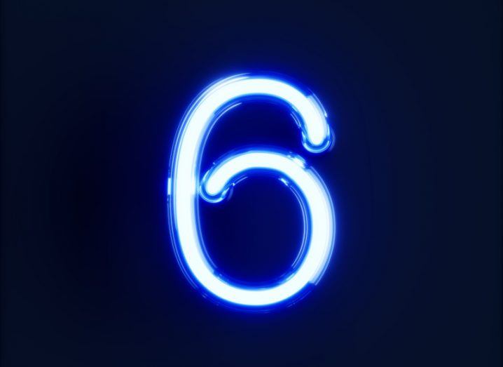 A neon lit image of the number six, with blue lighting and a dark background.