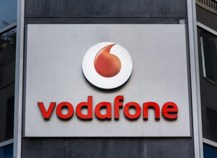 The Vodafone logo on a large sign on a building.