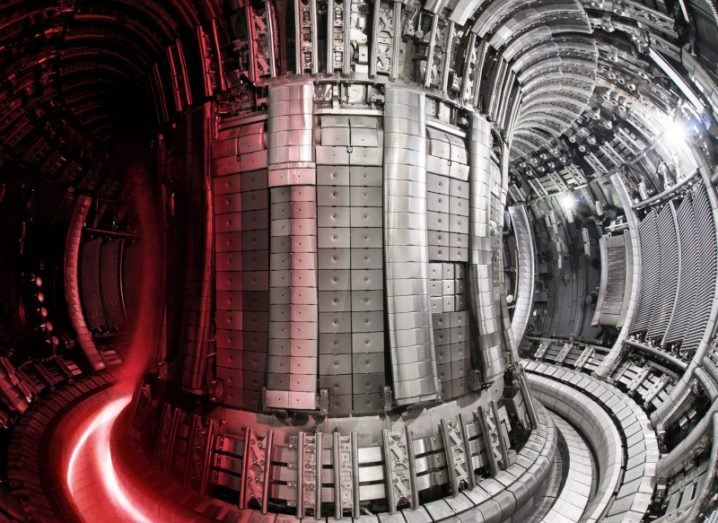 Interior of the Joint European Torus (JET), the largest and most powerful operational tokamak machine in the world, designed to create fusion energy. Red plasma is on the left part of the image.