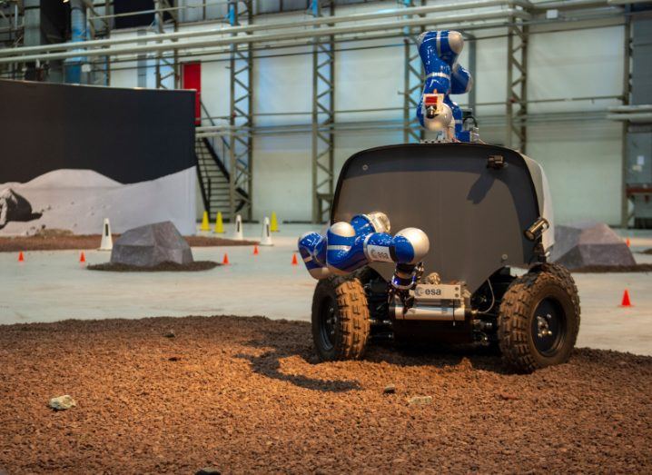 An ESA Analog-1 robot standing on ground that simulates the lunar surface.
