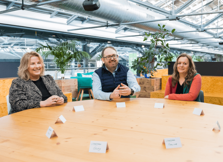 Three people seated around a table at Dogpatch Labs in Dublin.