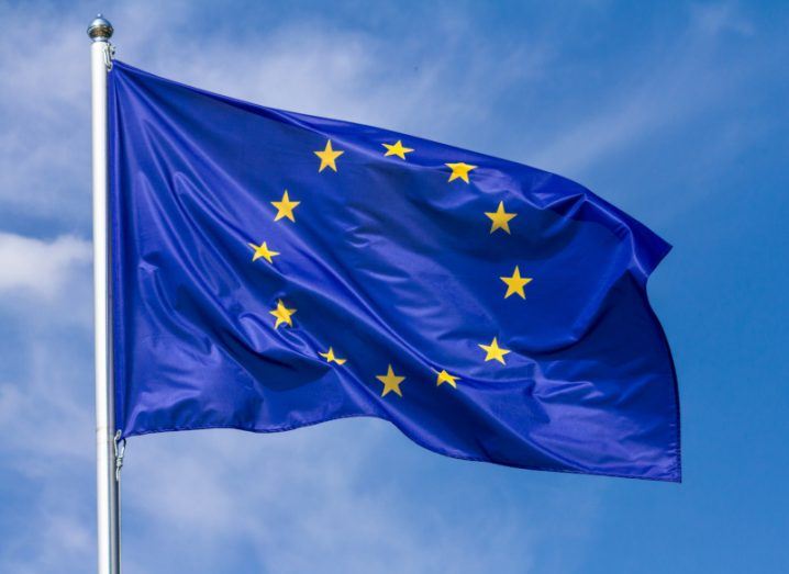 Image of the EU flag underneath a blue sky.