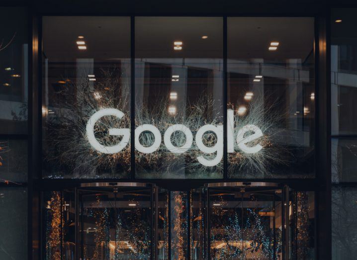 Google logo in white at the entrance of a building.