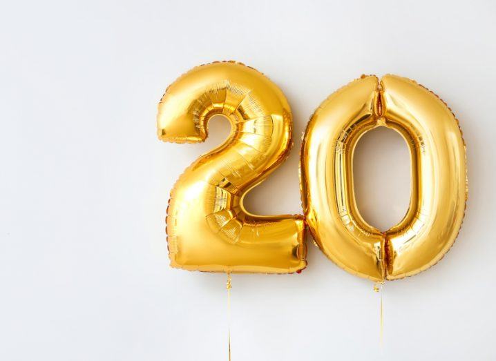Two golden balloons in the shape of two and zero showing the number twenty.