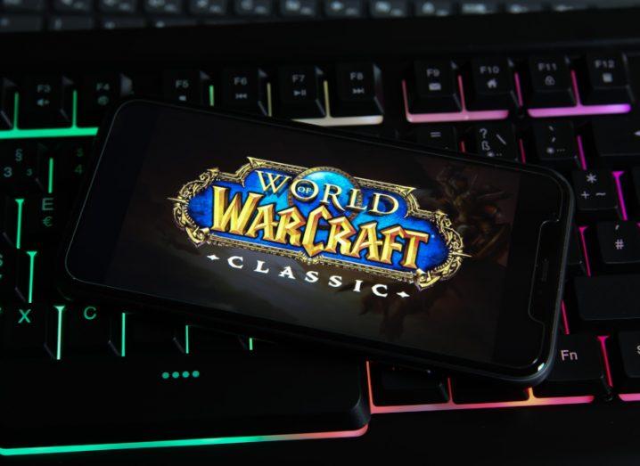 World of Warcraft graphic on a mobile screen placed on a keyboard.