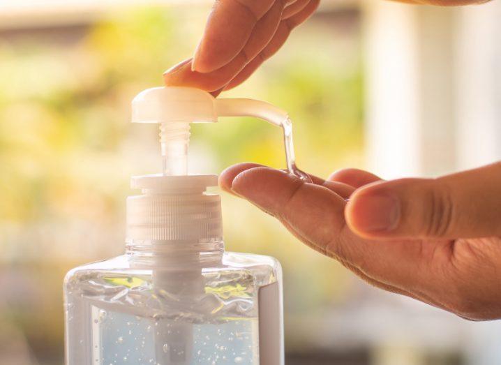 Liquid hand sanitiser being poured onto a person's hand.