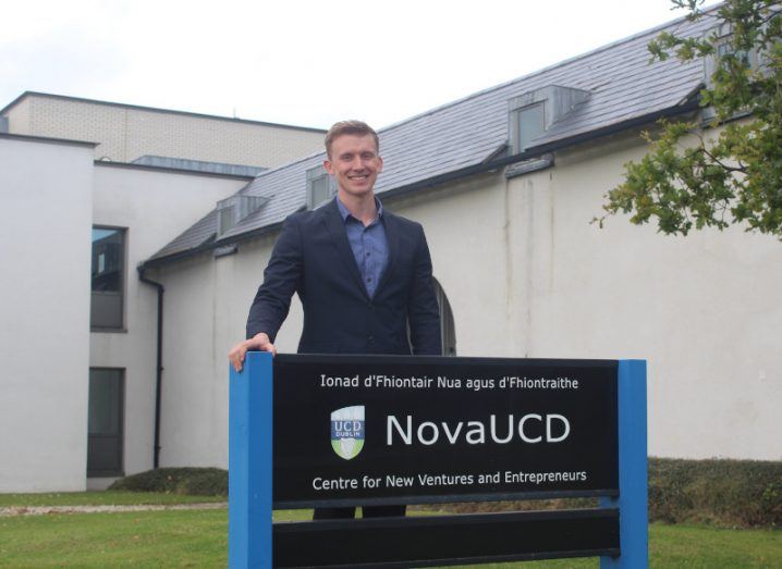 ReaDI-Watch founder and CEO Dave Byrne stands behind a sign for the NovaUCD centre at UCD.