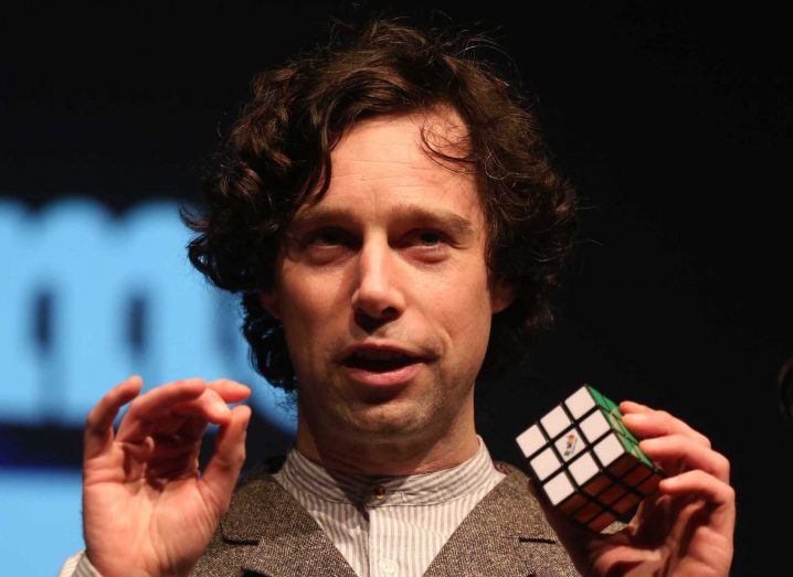 Close-up of Eoin Murphy as he delivers a science communication presentation using a solved Rubik’s cube as a prop.