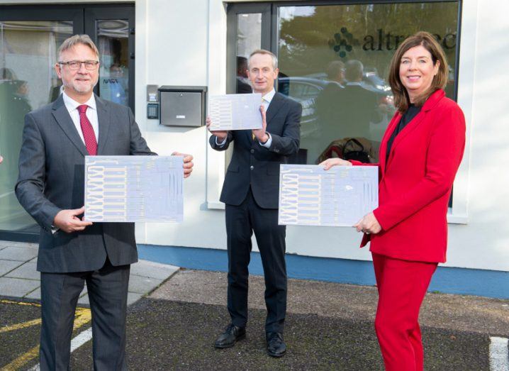 Pilot Photonics CEO William Oppermann, Enterprise Ireland CEO Leo Clancy and Kernal Capital partner Denise Sidhu all stand outside a building.