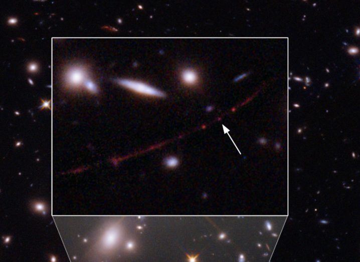 An image of distant galaxies magnified, with an arrow pointing to a small red dot that is the star Earendel.