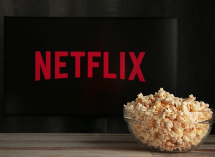 TV screen with Netflix logo behind a bowl of popcorn.