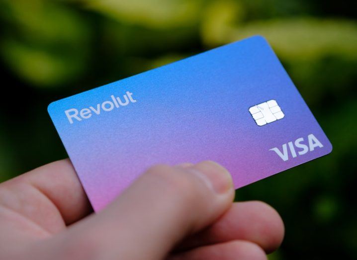 Close-up of a Revolut bank card held in a person's hand.