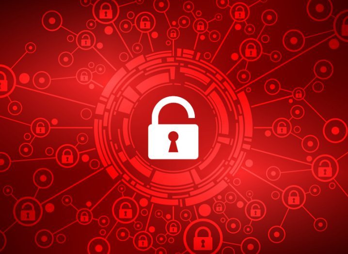 A white open padlock against a red background. There is a network of other padlocks connected to the centre symbolising a cyberattack.