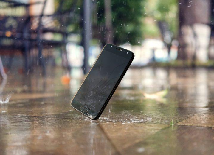 Smartphone falling on ground in the rain.