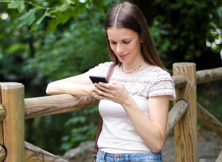 Woman using her mobile phone in a park.