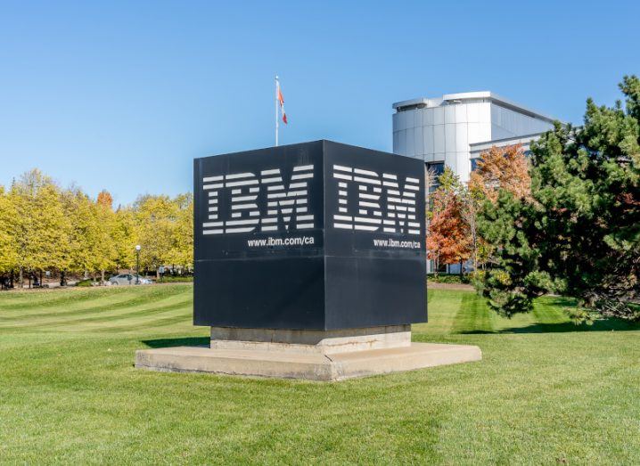 IBM logo on a black cube outside of one its offices in the background.