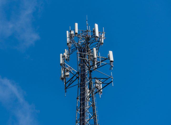 Mobile broadband tower with a clear blue sky above it.