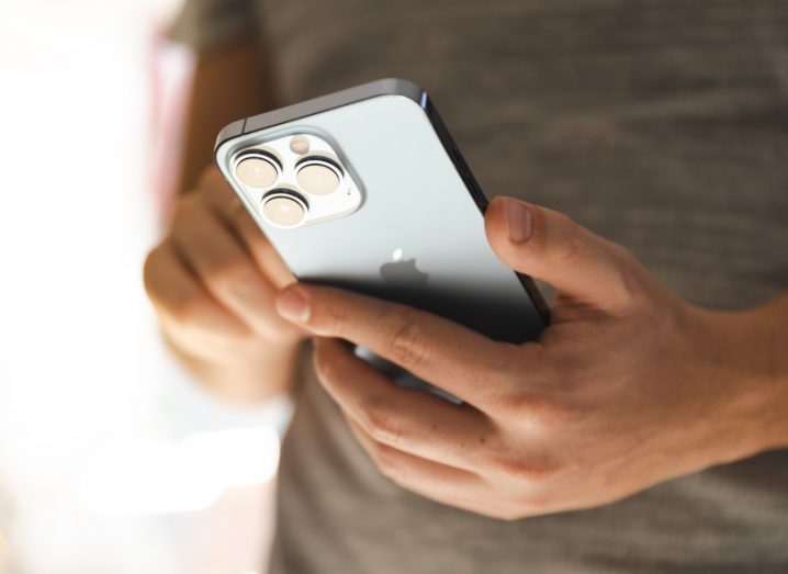 Apple iPhone being held by a person.