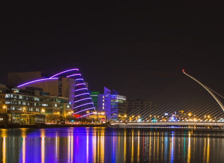 A view of Dublin city at night with the Convention Centre lit up.