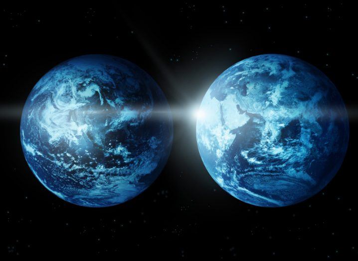 Two Earths floating side by side with the light of the sun behind them, with a black background.