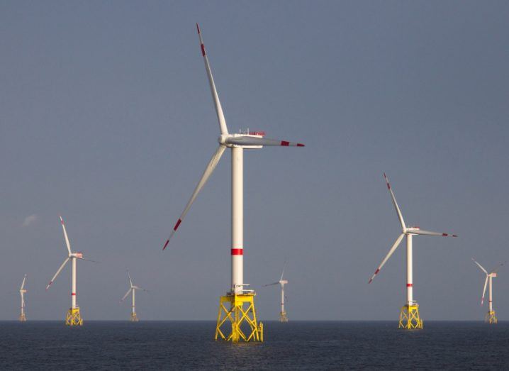 An offshore windfarm featuring seven turbines on an overcast day.