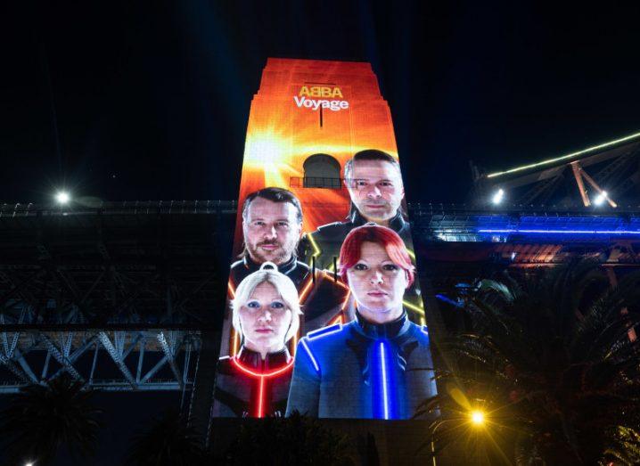 A brightly coloured advertisement for ABBA's digital show is lighting up the side of the Sydney Harbour Bridge.