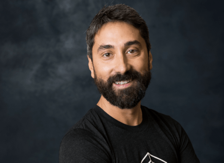 Headshot of TrueLayer CEO Francesco Simoneschi. He is bearded and wearing a black t-shirt in a dark grey background.