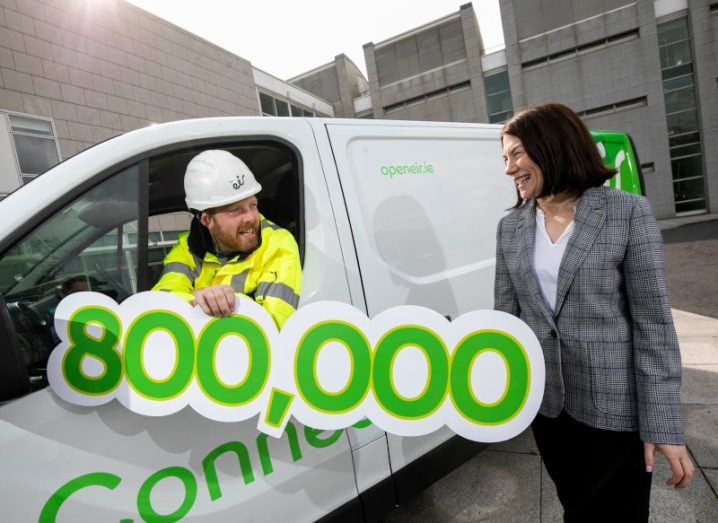 Open Eir technician Colin Kennelly with his head sticking out of the window of a van, chatting to Open Eir Wholesale managing director Eavann Murphy.