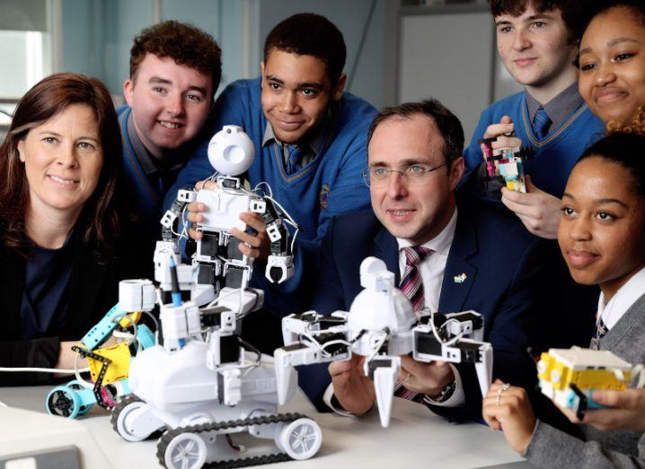 Patricia Scanlon, Ireland's AI Ambassador and Minister of State Robert Troy, TD, pictured with schoolchildren looking at a machine using AI.
