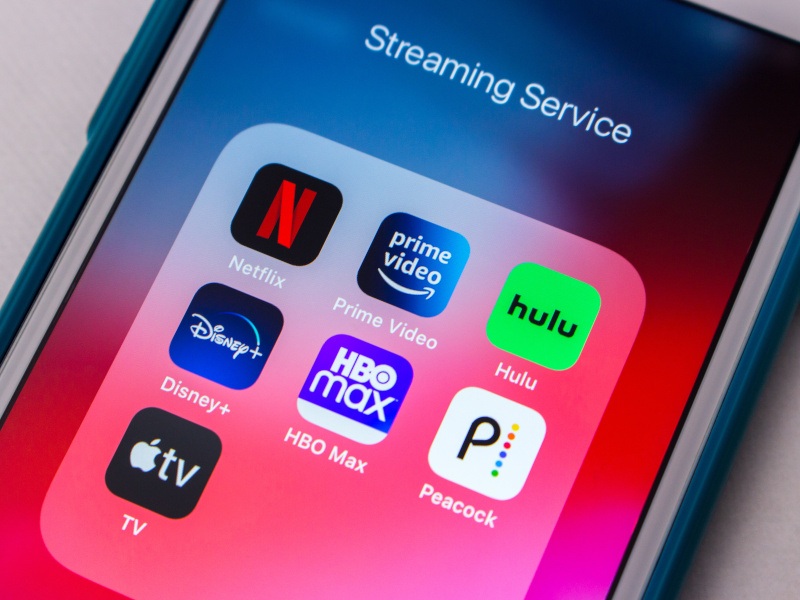 A phone screen showing a number of streaming apps, including Netflix, Prime, Hulu, Disney+ and HBO Max.