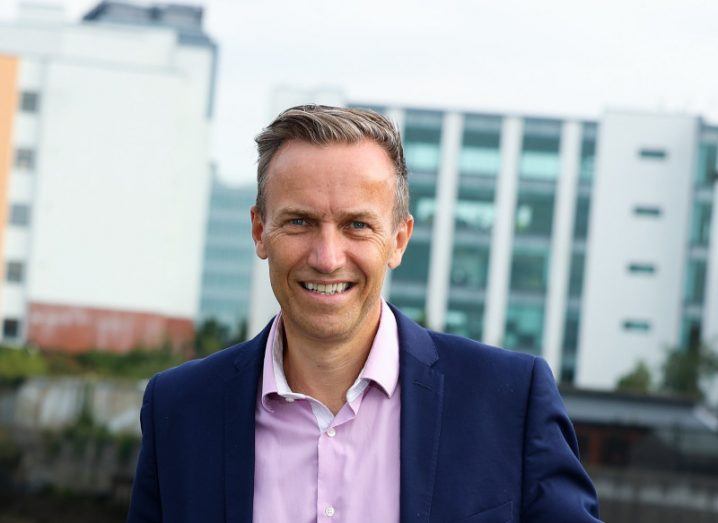 Headshot of Webdoctor CEO David Crimmins with the skyline of the Dublin docklands in the background.