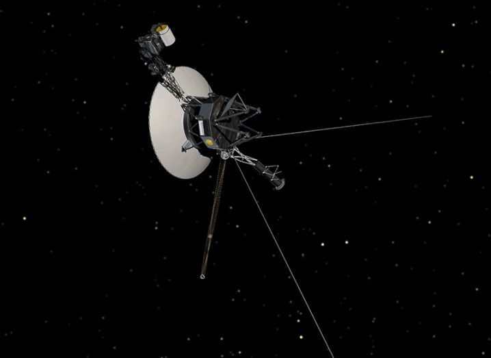 Illustration of the NASA Voyager 1 spacecraft in deep space, surrounding by a black background with some stars visible in the distance.