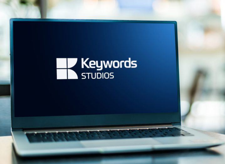Laptop with Keywords Studios logo on the screen.