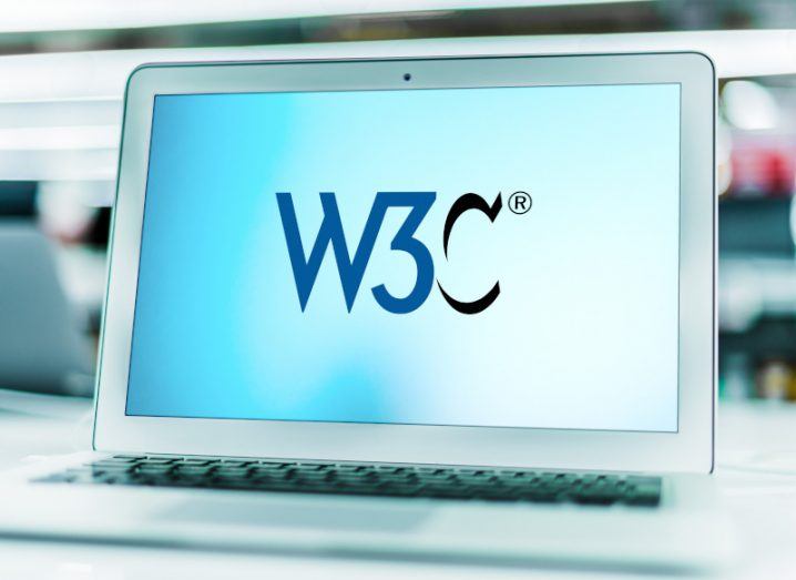 Laptop in an office with the W3C logo on the screen. W3C refers to the World Wide Web Consortium.