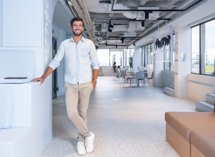 Hanno Renner, CEO and co-founder of Personio, leaning against a counter in a bright modern office.