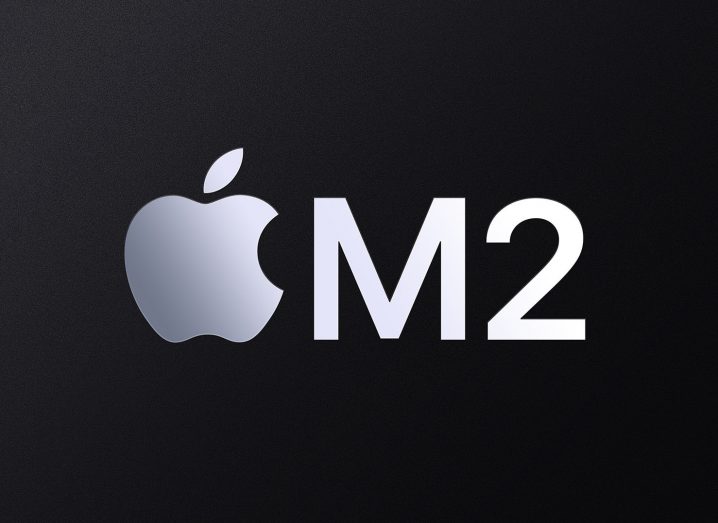 Apple logo with the text M2 next to it on a black background.