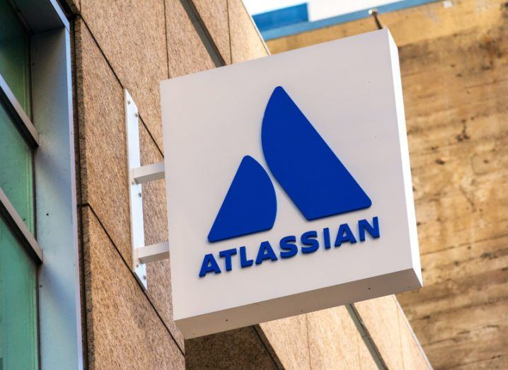 Atlassian logo on a sign attached to a building.