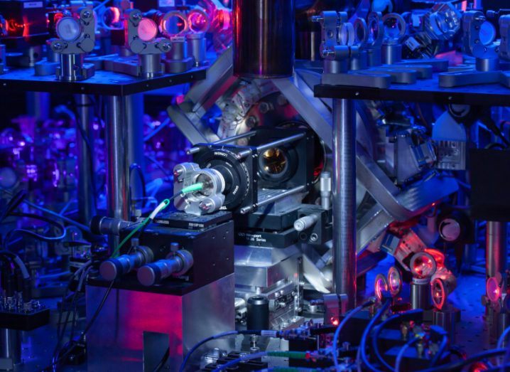 An ion trap used as part of a quantum encryption experiment, in the middle of a device with red and blue lighting.