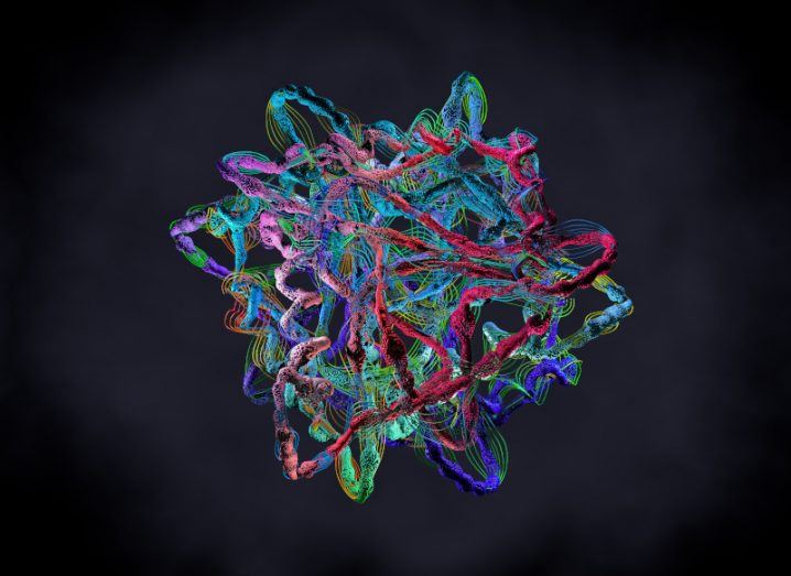 An illustration of a multi-coloured protein consisting of multiple strings wrapped around each other, floating with a black background.