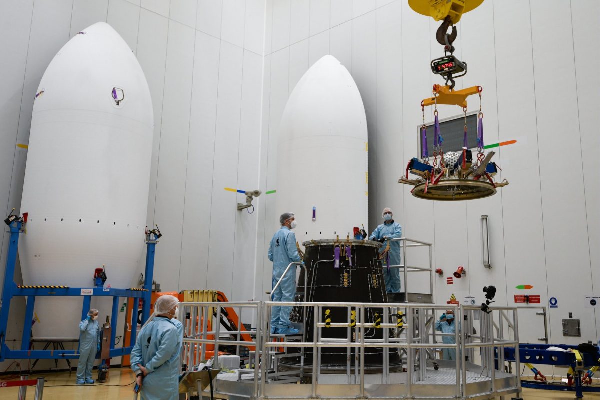 A group of scientists in a warehouse constructing a satellite. It is the Lares-2.