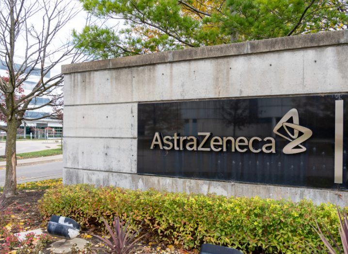 The AstraZeneca logo on a wall outside an office building.