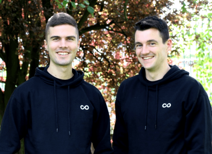 Two men standing together and smiling with a tree in the background. They are the co-founders of Noloco.