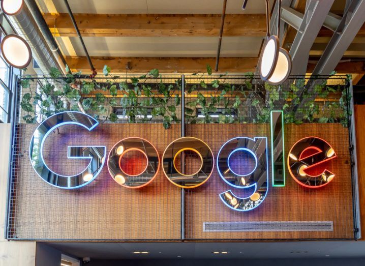 Google logo with different colours on a wooden wall in a building.