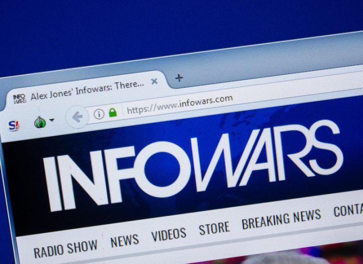 A close-up of the Infowars website on a laptop. Infowars is founded by Alex Jones.